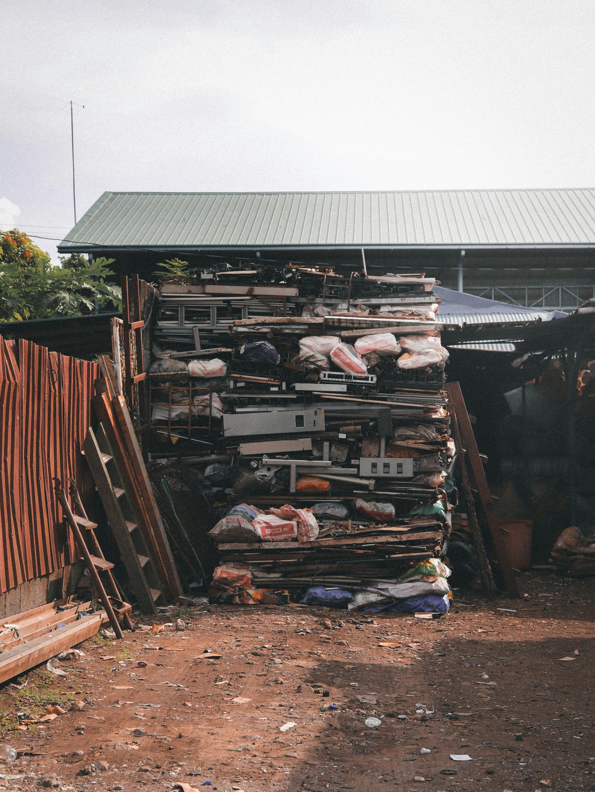 A towering pile of assorted discarded items outdoors
